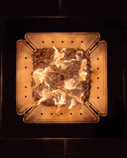 Smokeless propane campfire powered by the Zutto SP1 adapter in a Snow Peak Takibi fire pit, viewed from above with Jikaro table