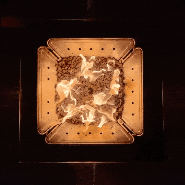 Smokeless propane campfire powered by the Zutto SP1 adapter in a Snow Peak Takibi fire pit, viewed from above with Jikaro table