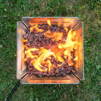 Overhead view of the Zutto SP1 smokeless propane gas adapter installed in a Campingmoon MT-045 fire pit with bright swirling flames